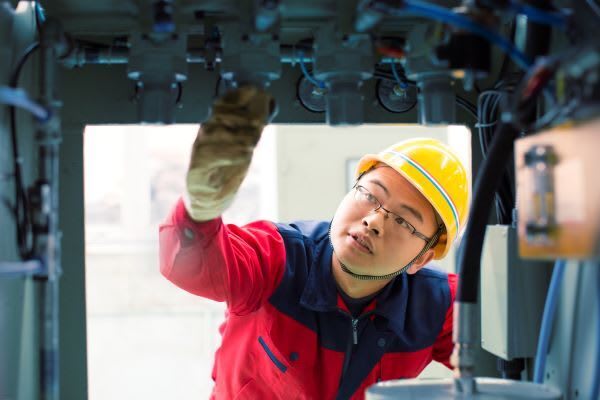 Facilities management maintenance engineer inspects electric system installation